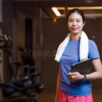 portrait-southeast-asian-personal-trainer-healthy-women-standing-tablet-training-program-happy-smiling-private-luxury-371858208